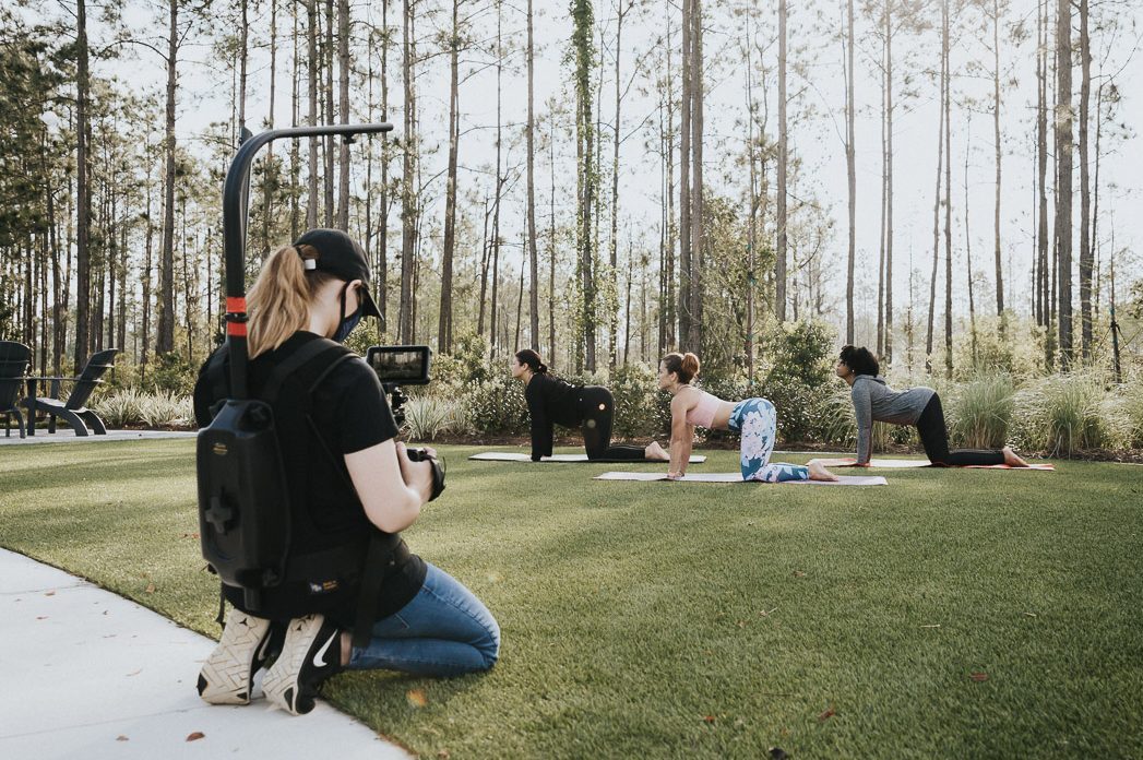 Woman capturing video of yoga students