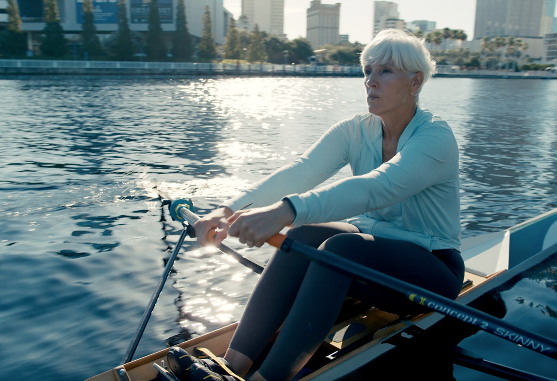 Photo of a woman rowing through Downtown Tampa