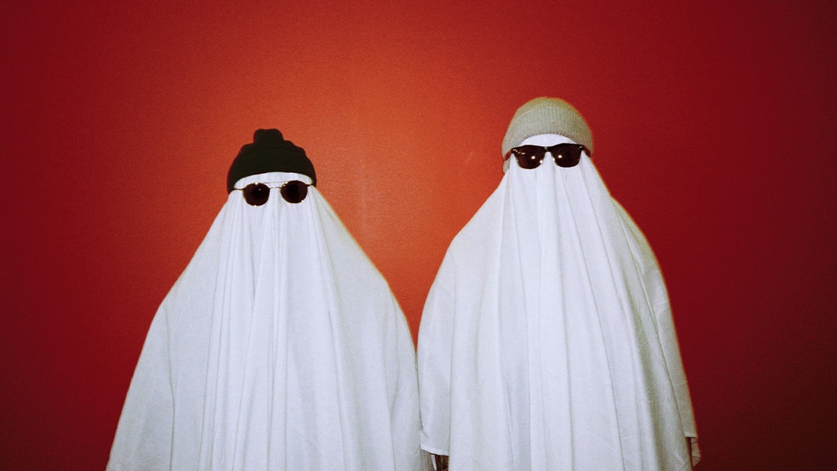 Janel and Julianne dressed up as ghosts with hats and sunglasses for Halloween