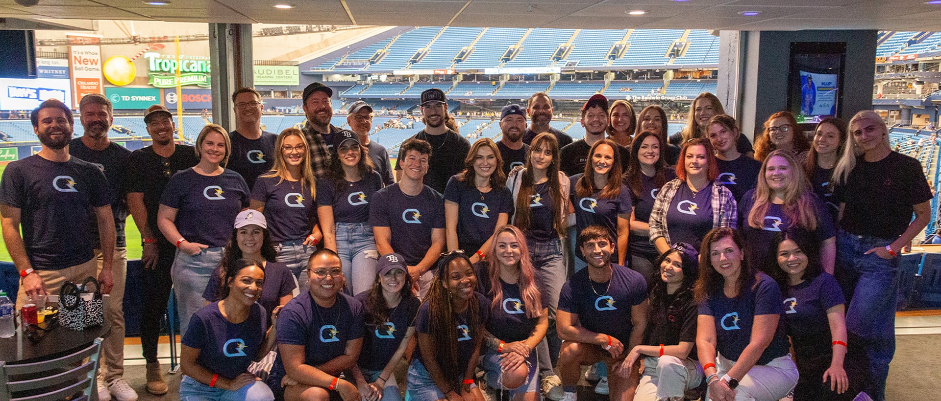Photo of the CR team at a Rays game wearing matching CR-Rays logo t-shirts