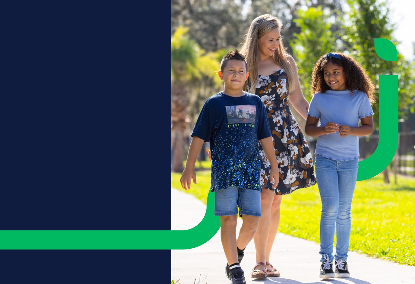 A photo of a woman walking with a young boy and girl. A thick green line ending with a lead winds behind them.